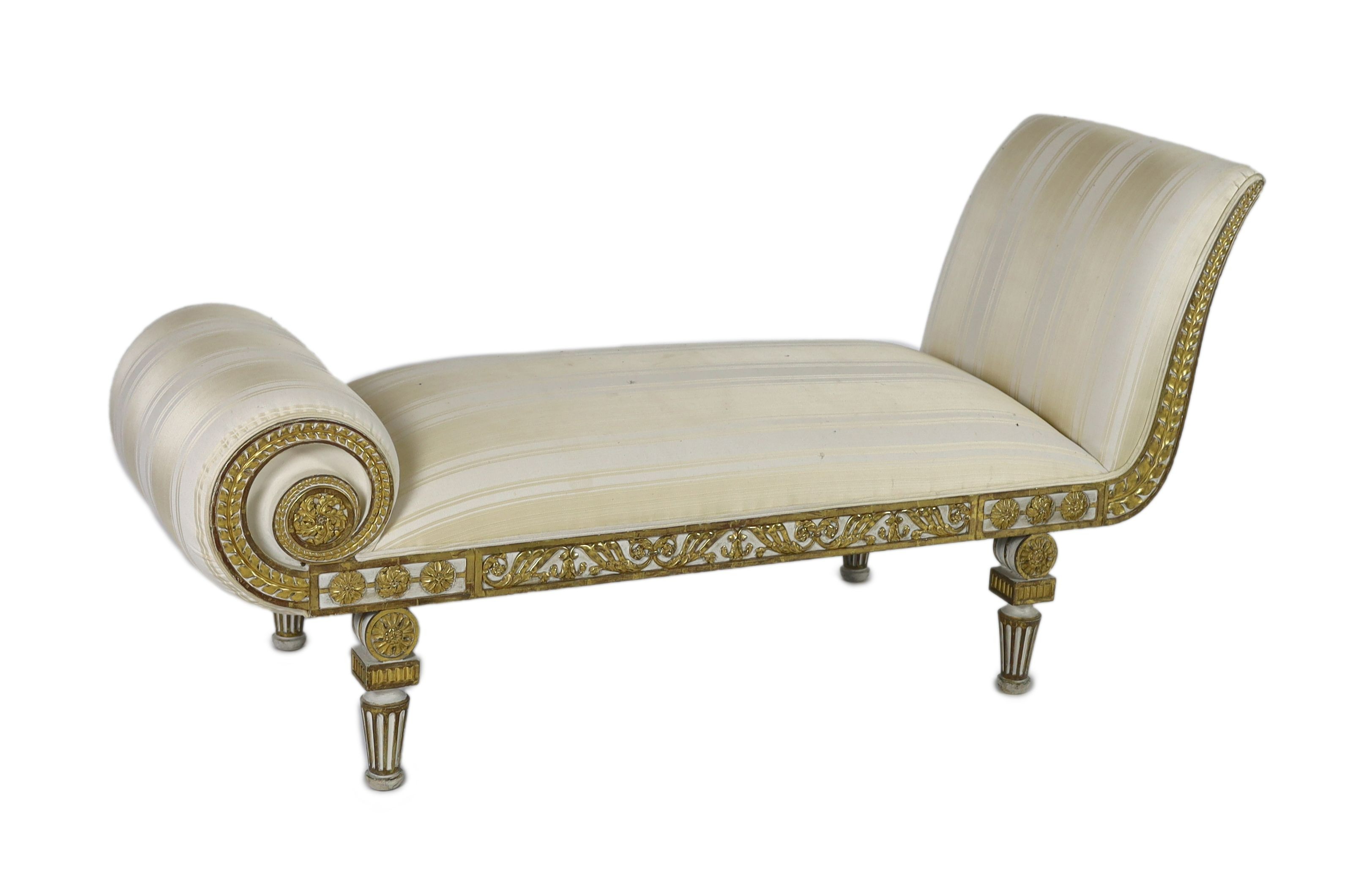 A Regency white painted and parcel gilt chaise longue, L.166cm W.63cm H.84cm